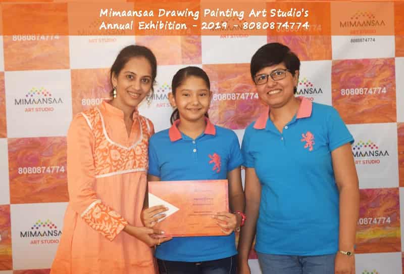 A Girl in Pink dress taking Best Drawing Award in kids category from Art Teacher