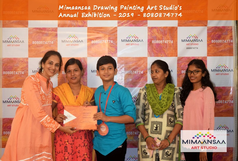 A Son getting Award for best visual Art painting along with his Mother Sister Aunty and Teacher